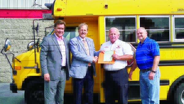 Star Photo/Abby Morris-Frye The Carter County School system has donated a Class A mini bus to the Carter County Sheriff's Department to be used for inmate work programs. Here, from left, Director of Schools Kevin Ward, Carter County Sheriff Dexter Lunceford, Carter County Board of Education Chairman Rusty Barnett and school system Transportation Manager Wayne Sams complete the transfer and turn over the title and keys to the bus.